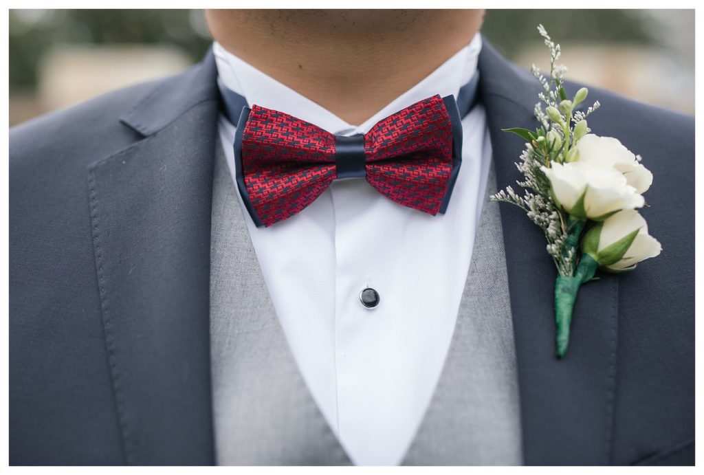 a groom's bowtie while waiting for his wedding at KLEA Banquet Hall