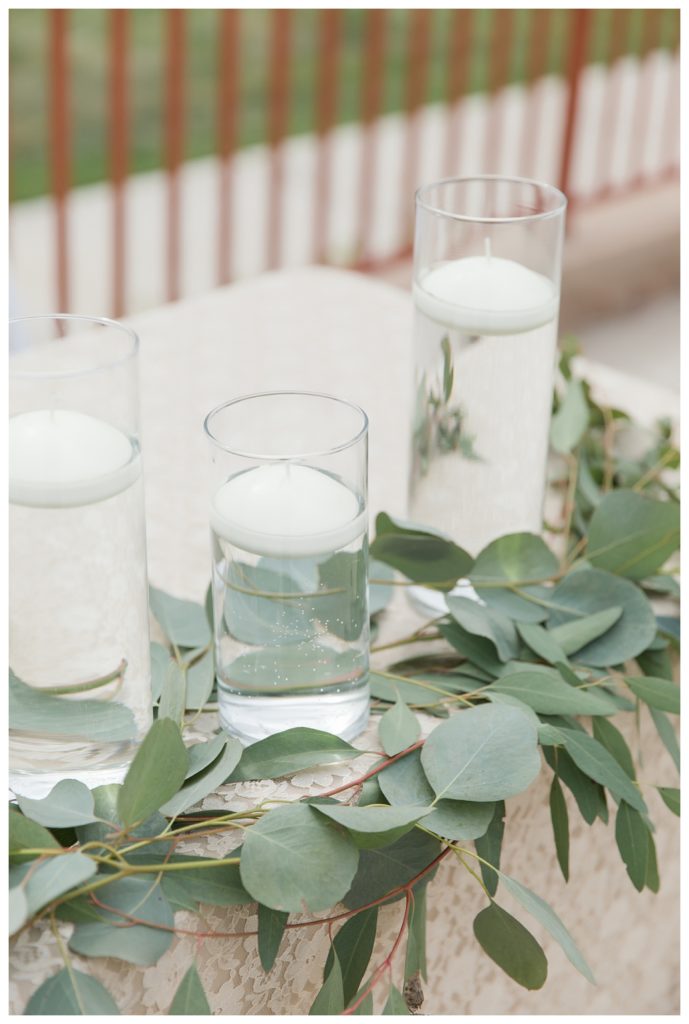 eucalyptus and candles decorate a table at wedding at KLEA Banquet Hall