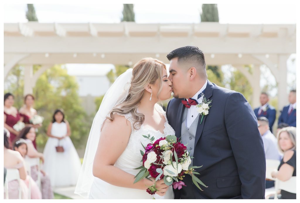 a first kiss at a wedding at KLEA Banquet Hall
