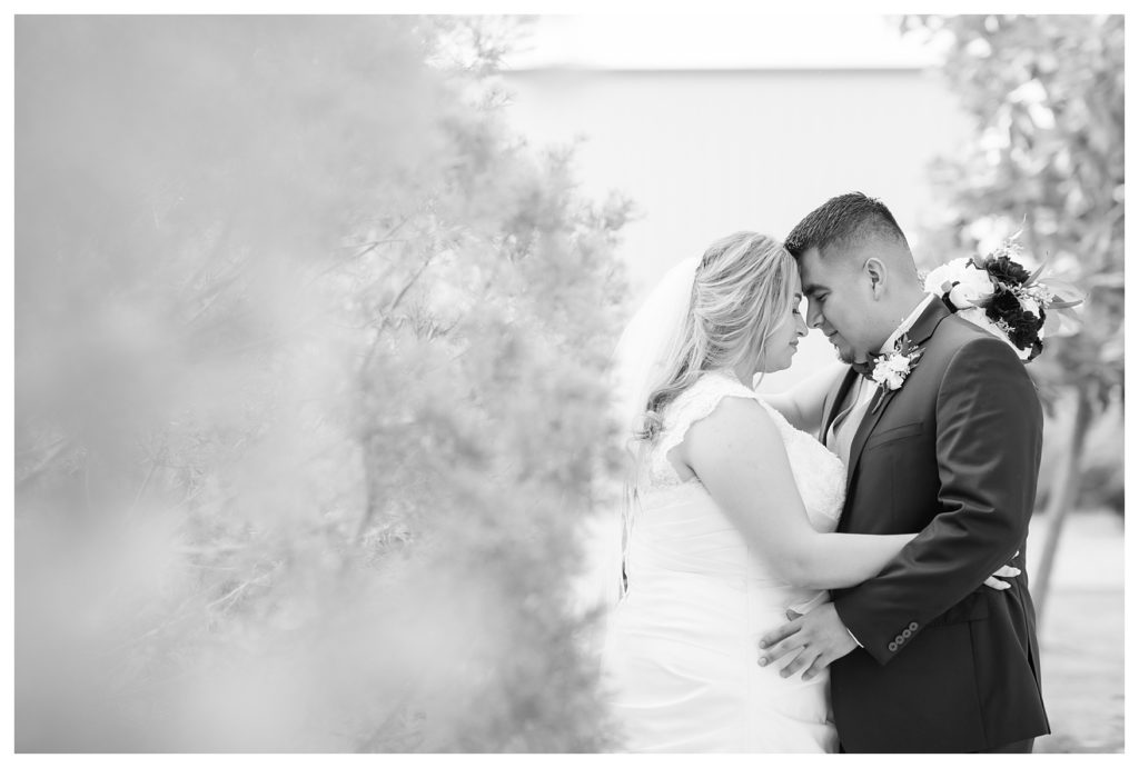 a black and white photo of a bride and groom at their wedding at KLEA Banquet Hall