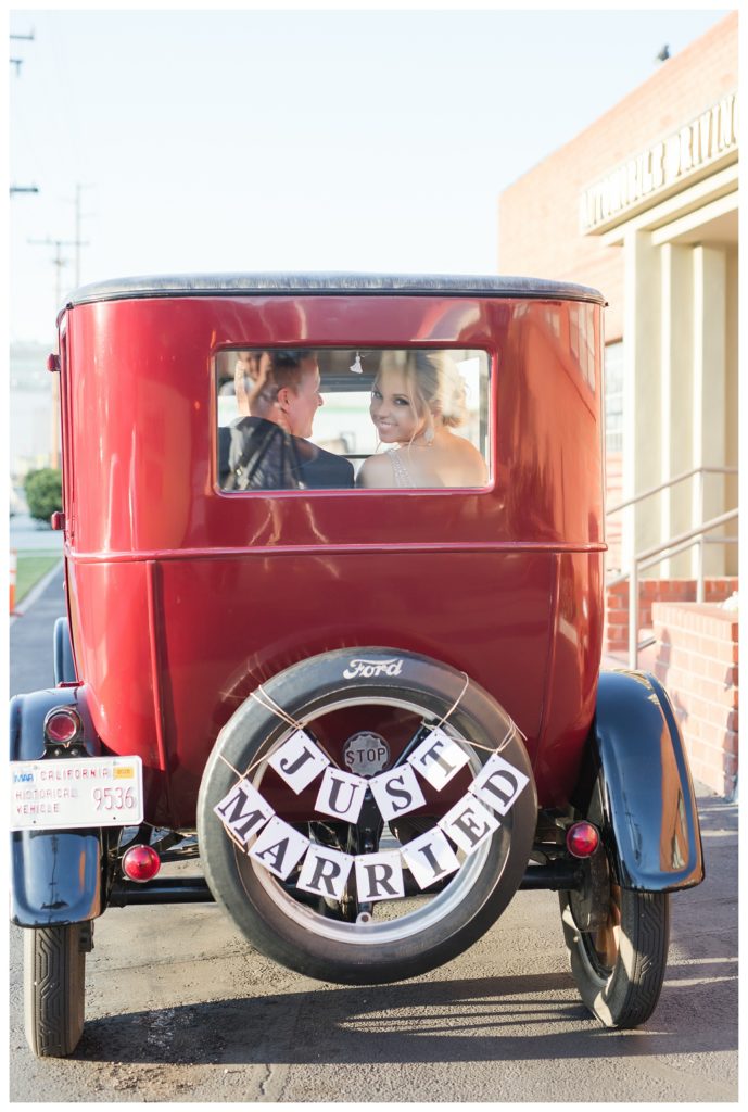 looking through the window of a vintage car after wedding at the Automobile Driving Museum in Segundo, California