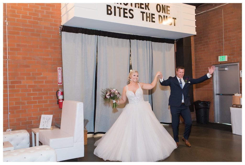 a bride and groom enter their reception at their wedding at the Automobile Driving Museum in Segundo, California