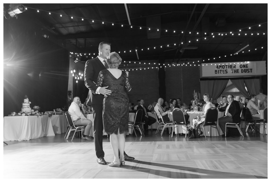 a groom dances with his mother at his wedding at the Automobile Driving Museum in Segundo, California