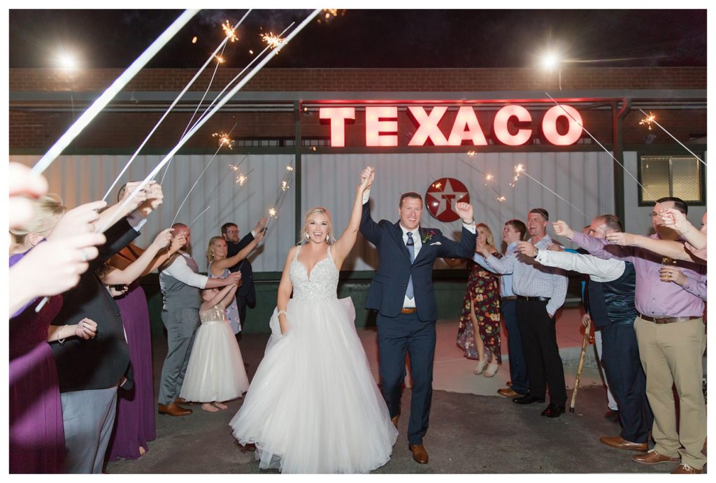 a bride and groom have a sparkler exit at their wedding at the Automobile Driving Museum in Segundo, California