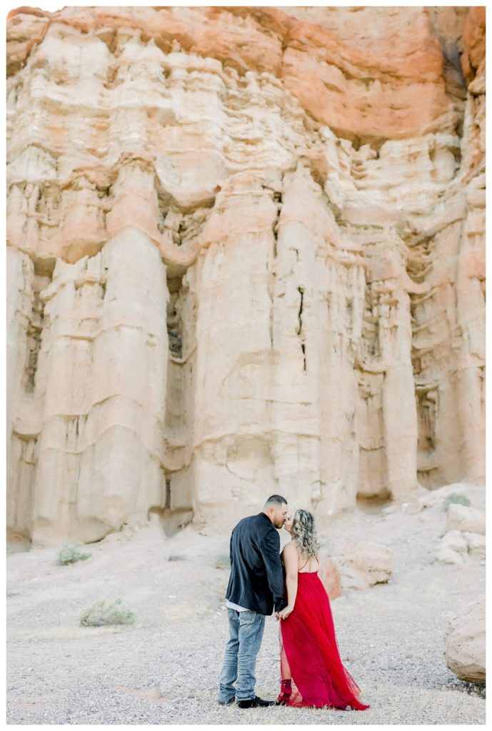 Red Rock Canyon engagement photos - couple in front of massive rock wall