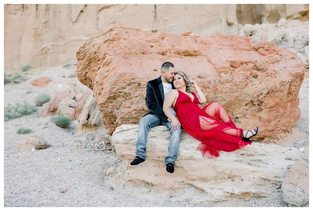 Red Rock Canyon engagement photos - couple sitting on a large rock