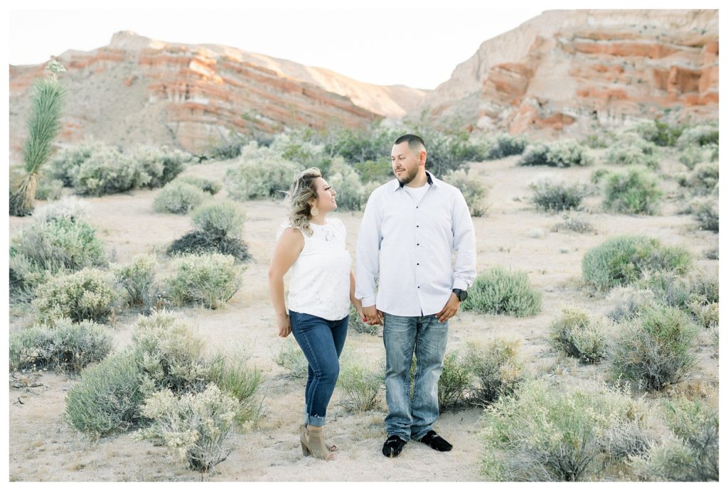 Red Rock Canyon engagement photos - couple walking through the desert