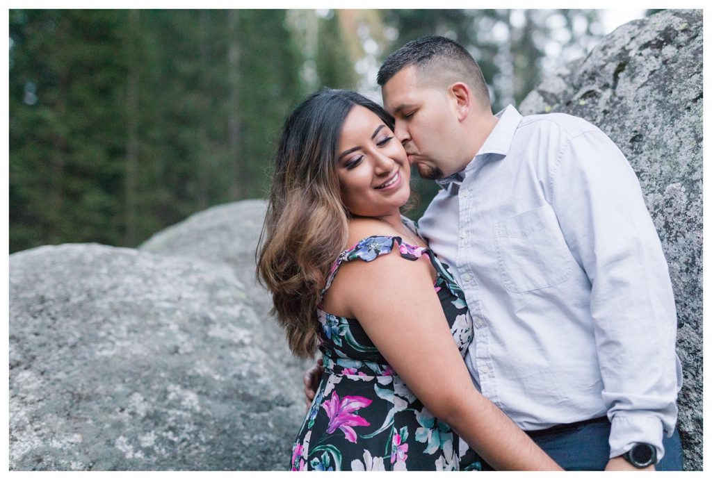 Engagement photos in Sequoia National Park - a man kisses his fiancee on the cheek