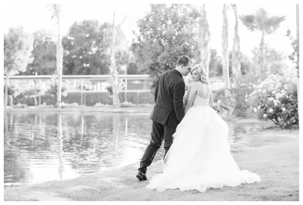 Park Place Events Wedding - bride and groom snuggling in front of a pond