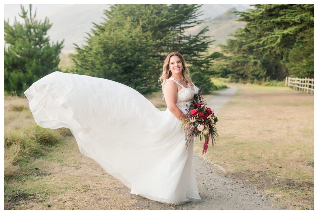 bride's dress flying in the breeze after a Big Sur elopement