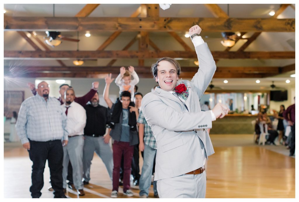 groom throws the garter at his wedding at Kern County Basque Club