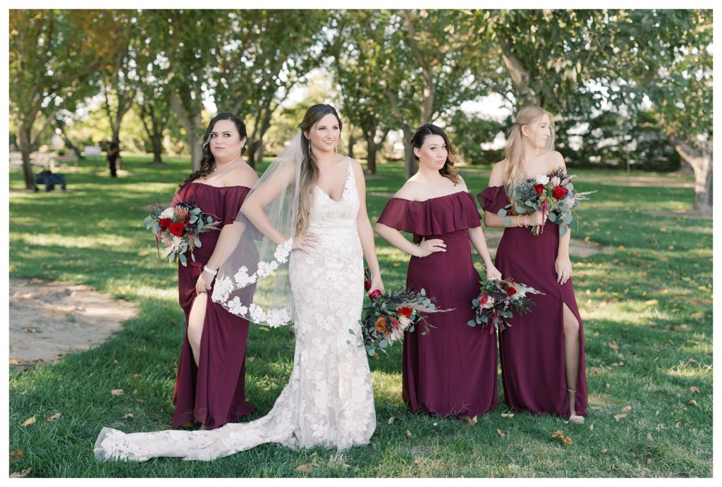 bride and bridesmaids posing for photos before a wedding at Kern County Basque Club