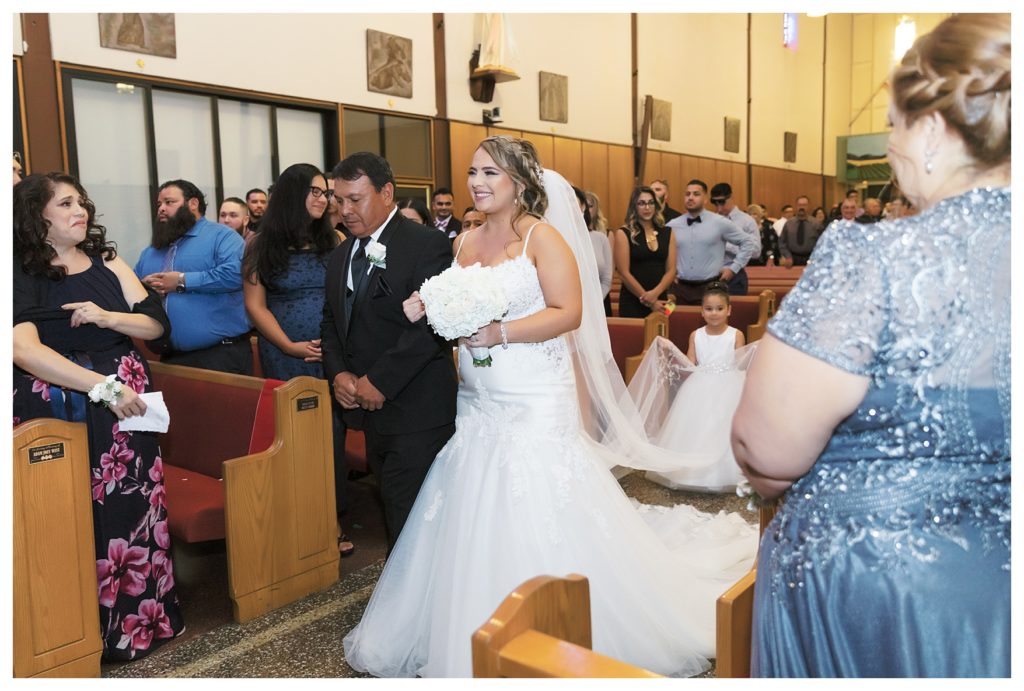 bride and her father walk up the aisle at a Rio Bravo Country Club wedding