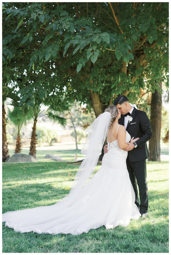 a bride and groom cuddle at their Rio Bravo Country Club wedding