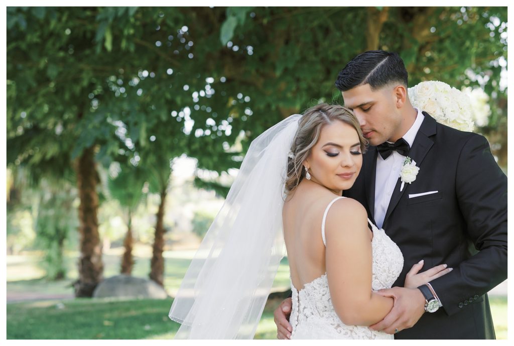 groom kissing bride on the cheek at a Rio Bravo Country Club wedding