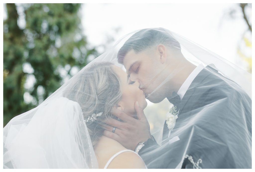 bride and groom under a veil at a Rio Bravo Country Club wedding