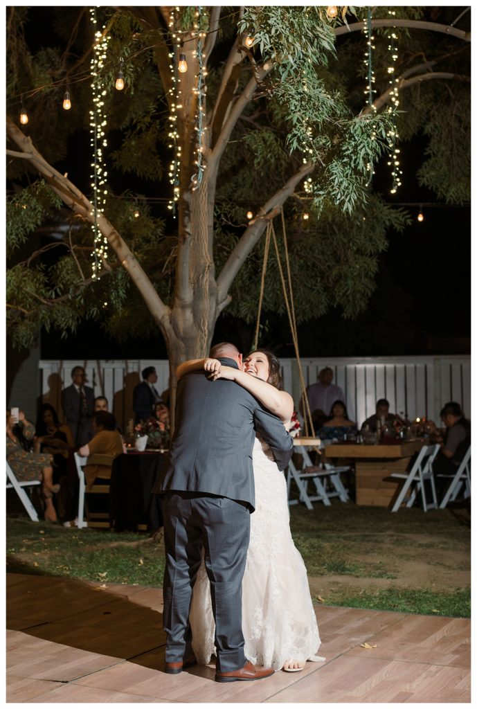 first dance beneath twinkle lights at a wedding at The Belle Rae