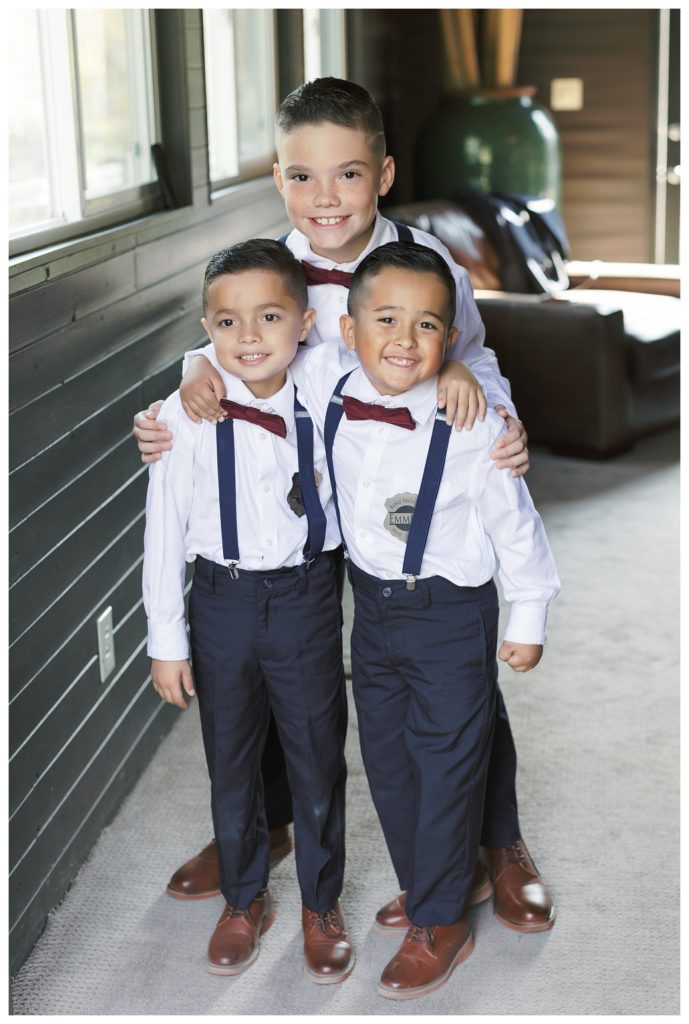 adorable ringbearers pose for a photo before a wedding at JEH Ranch