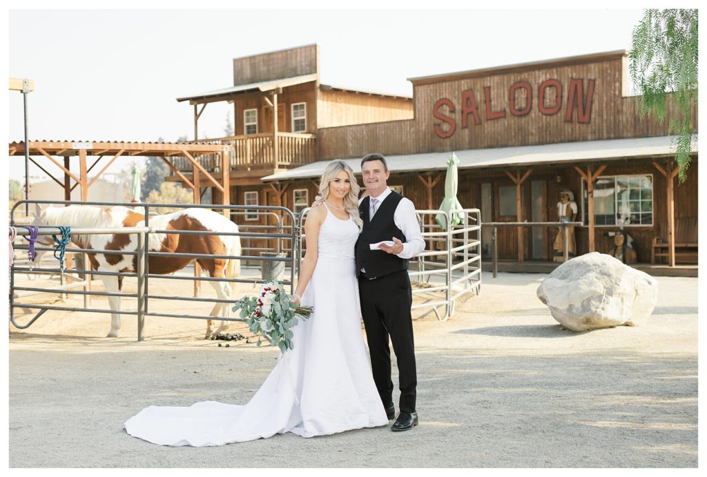 a bride and groom portrait with horses at awedding at JEH Ranch