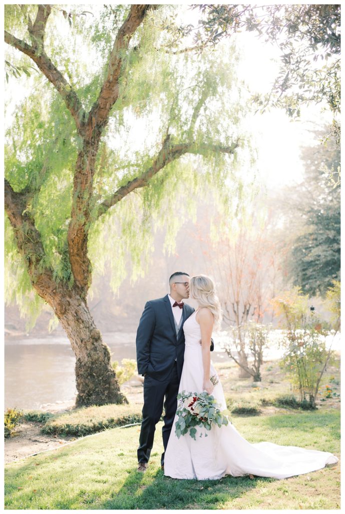 a bride and groom kiss for photos during golden hour at their wedding at JEH Ranch