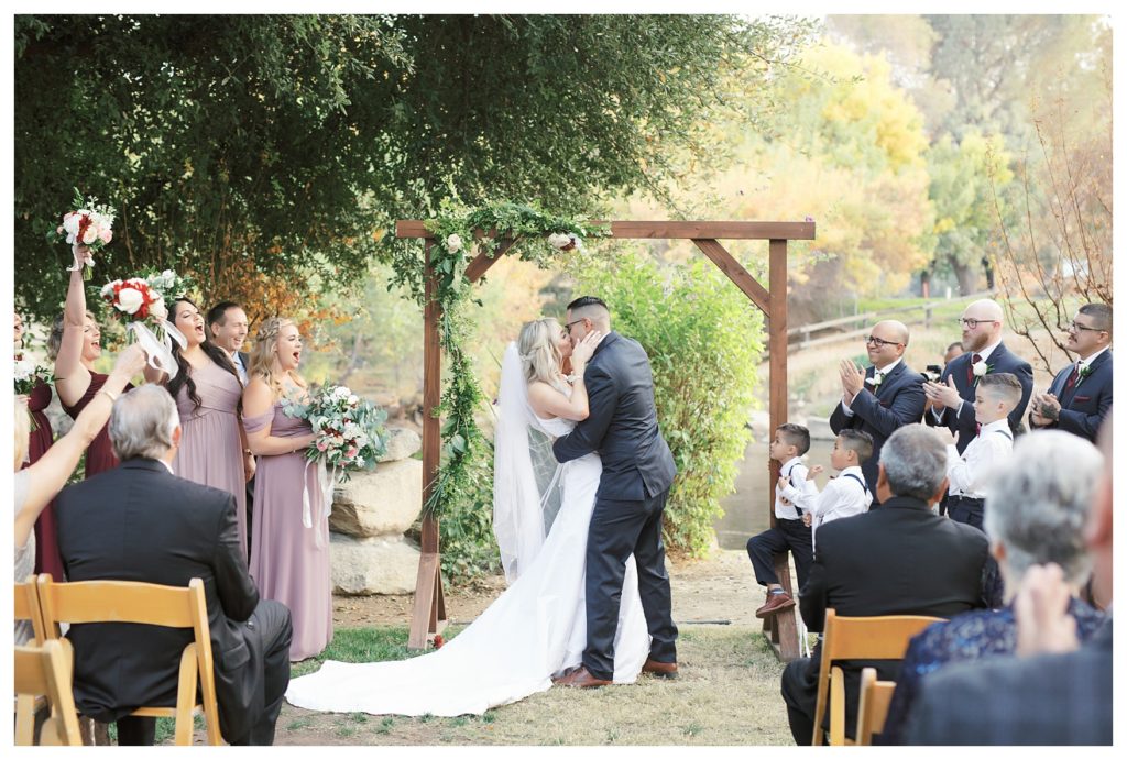 a first kiss during the ceremony at wedding at JEH Ranch
