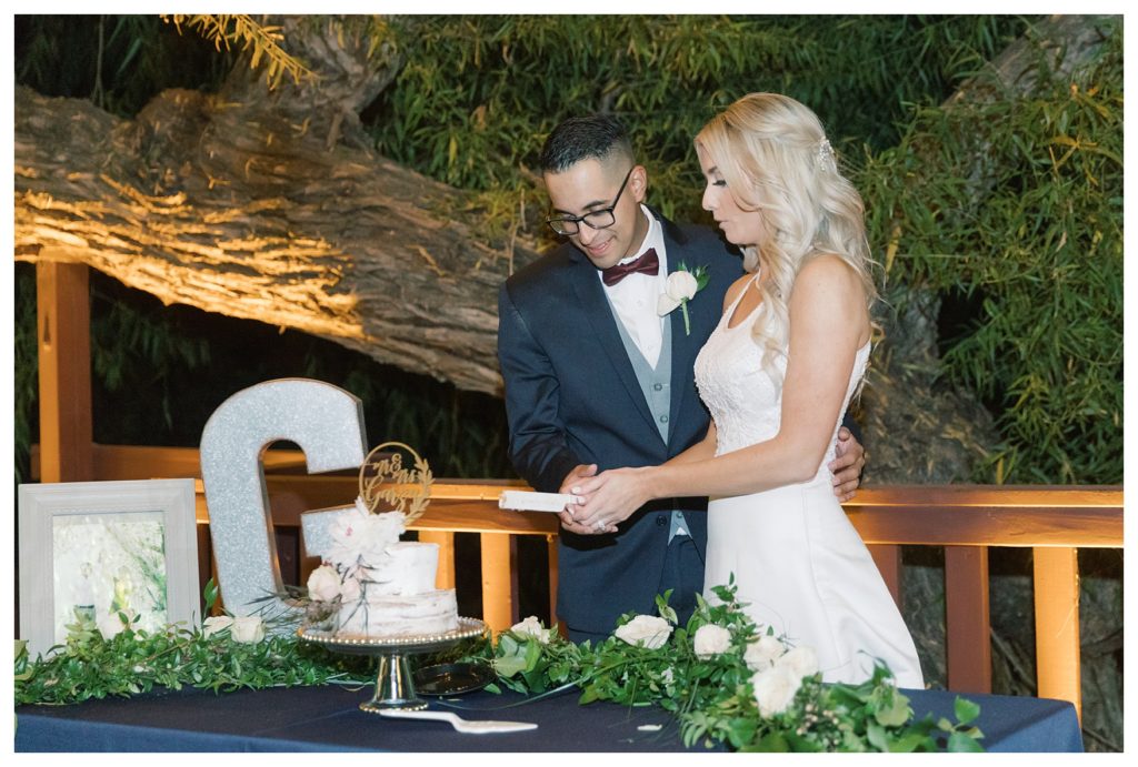 bride and groom cut their wedding cake at their wedding at JEH Ranch