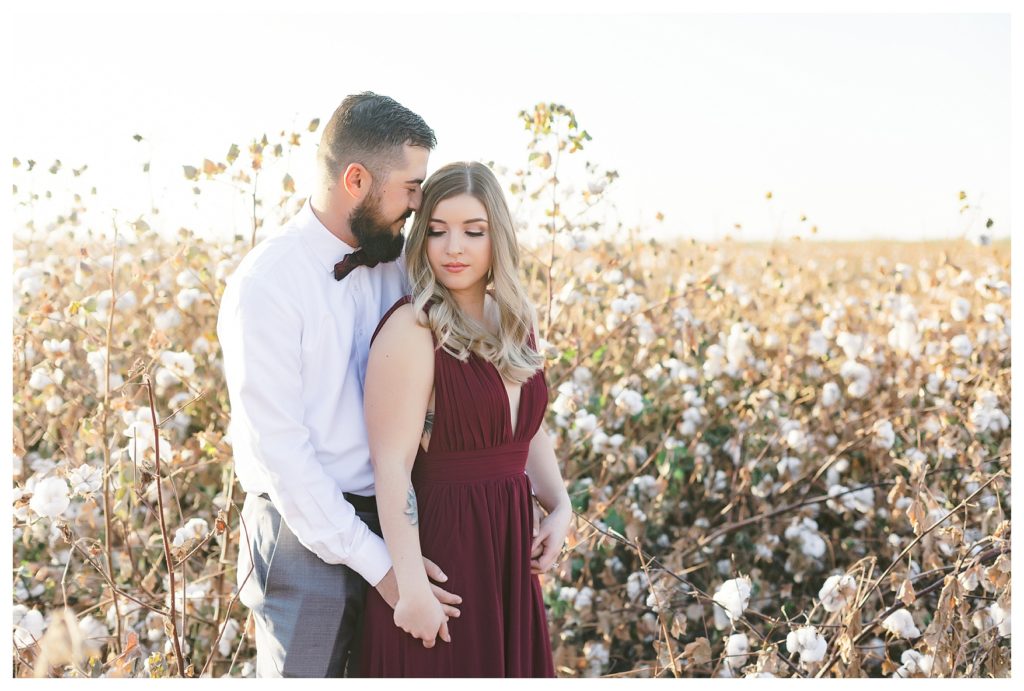 a romantic moment for a couple during their cotton field engagement photos