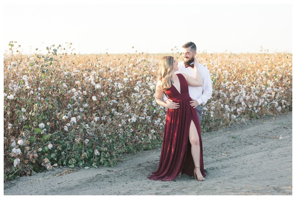 a couple in front of cotton field engagement photos