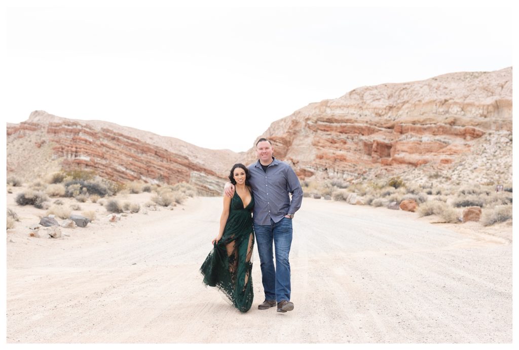 a couple walks through the desert during their desert engagement photos