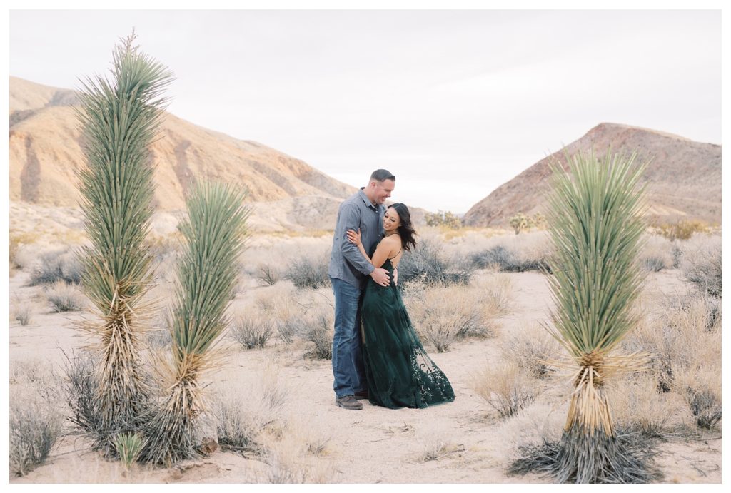 a romantic moment between a couple during their desert engagement photos