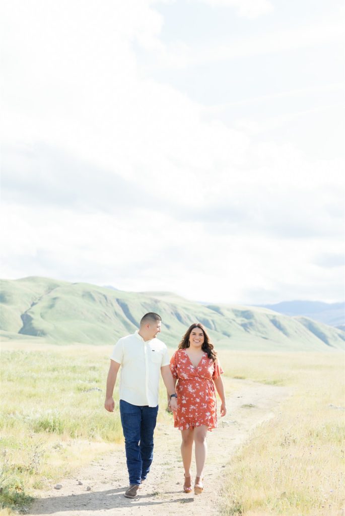 a couple walks through the fields during engagement photos at Wind Wolves Preserve