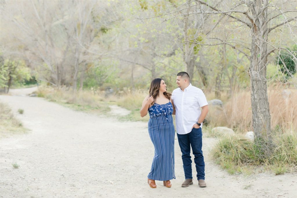 a couple walks along a path during engagement photos at Wind Wolves Preserve