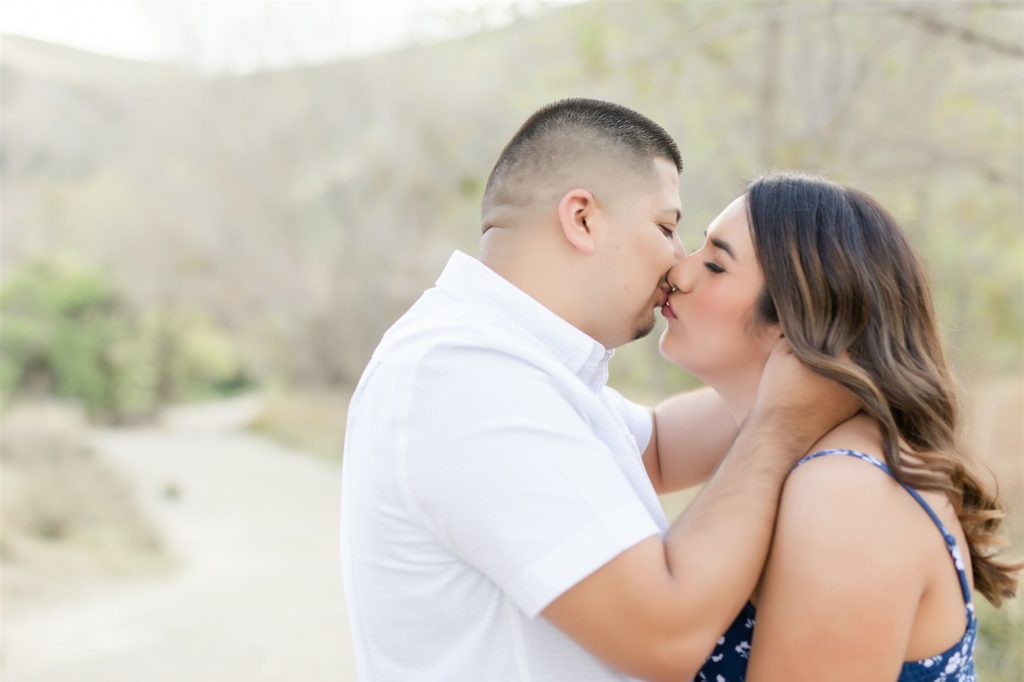 a couple kisses during engagement photos at Wind Wolves Preserve