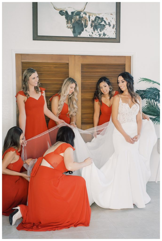 bridesmaids help a bride get ready for her rescheduled COVID wedding
