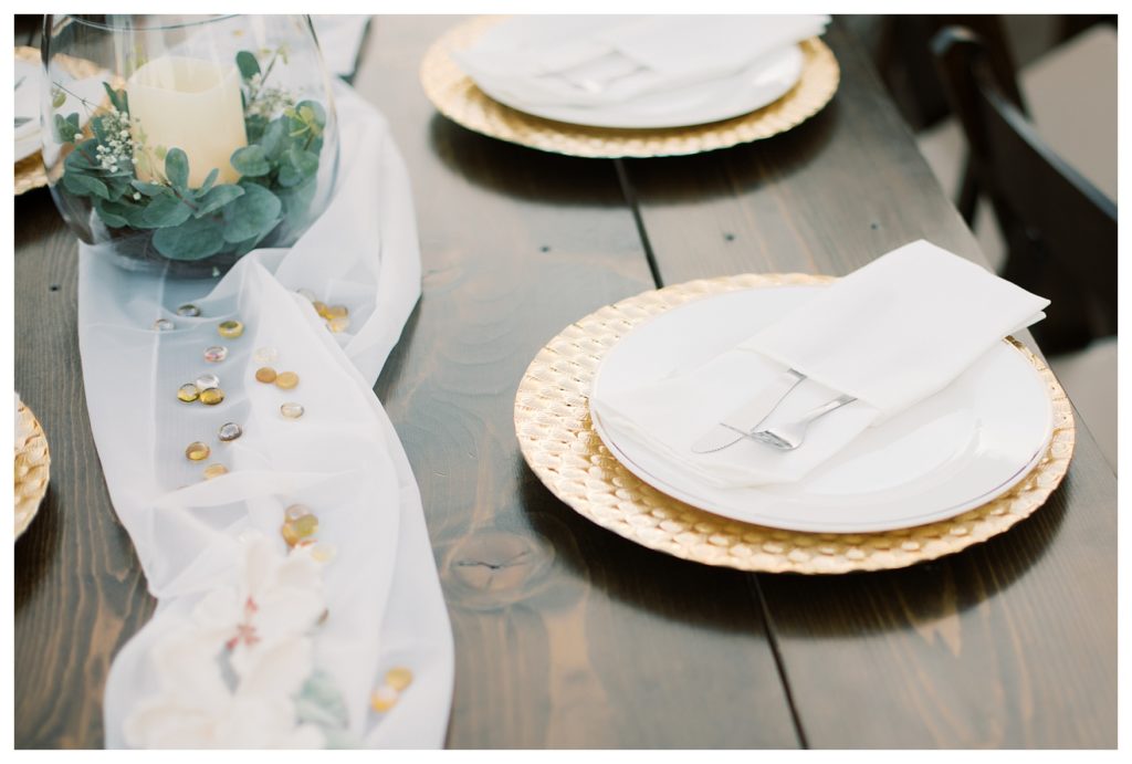 beautiful gold and white table settings at a rescheduled COVID wedding