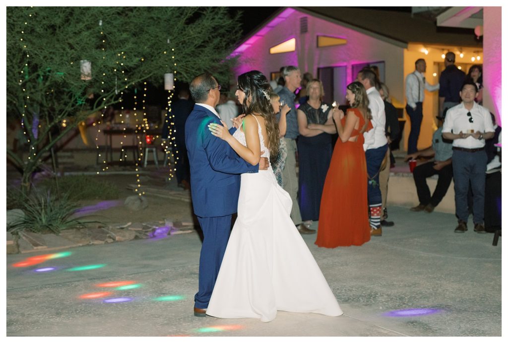 a bride dances with her dad at her rescheduled COVID wedding reception