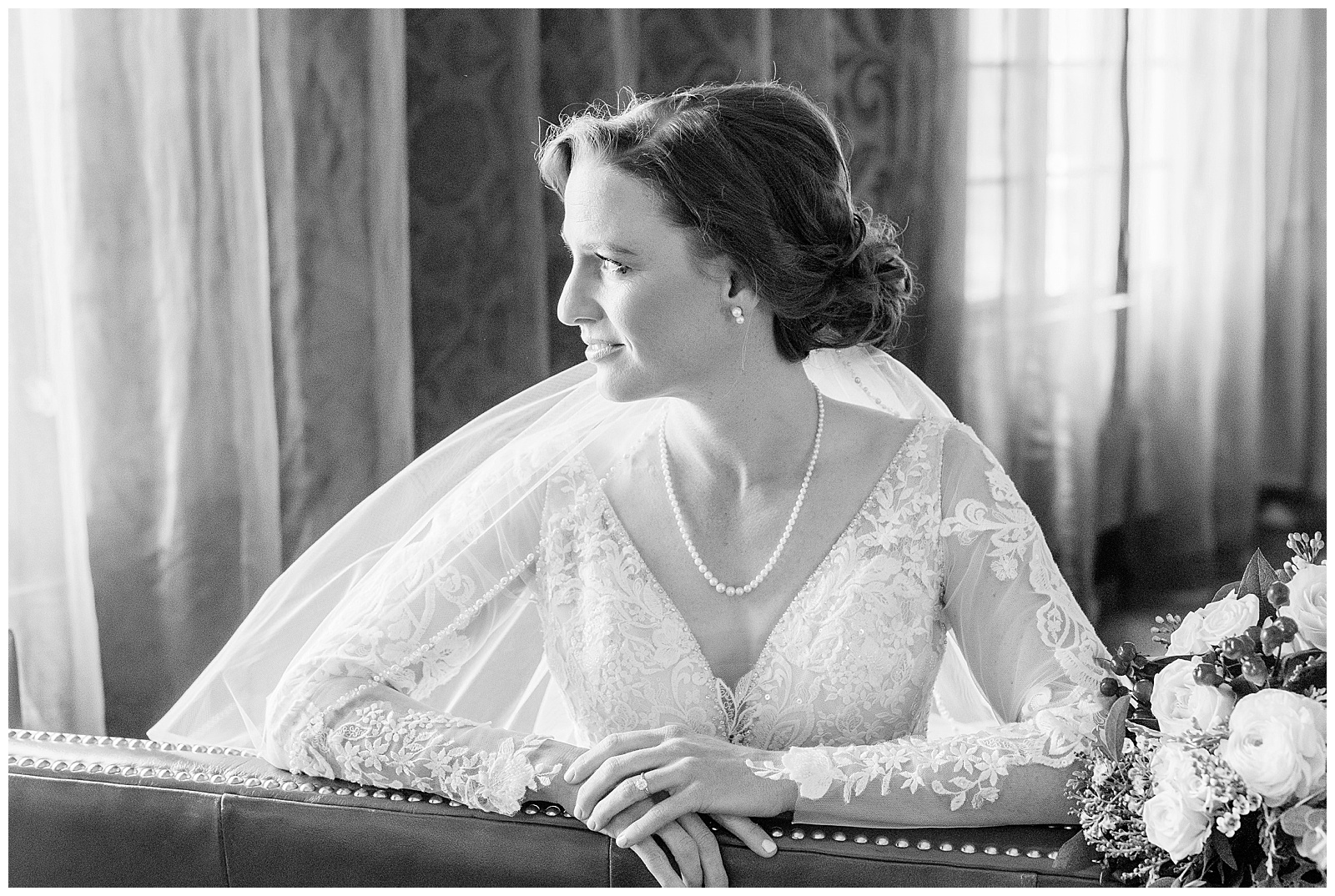 a bride looks out the window before her winter wedding in Bakersfield, CA