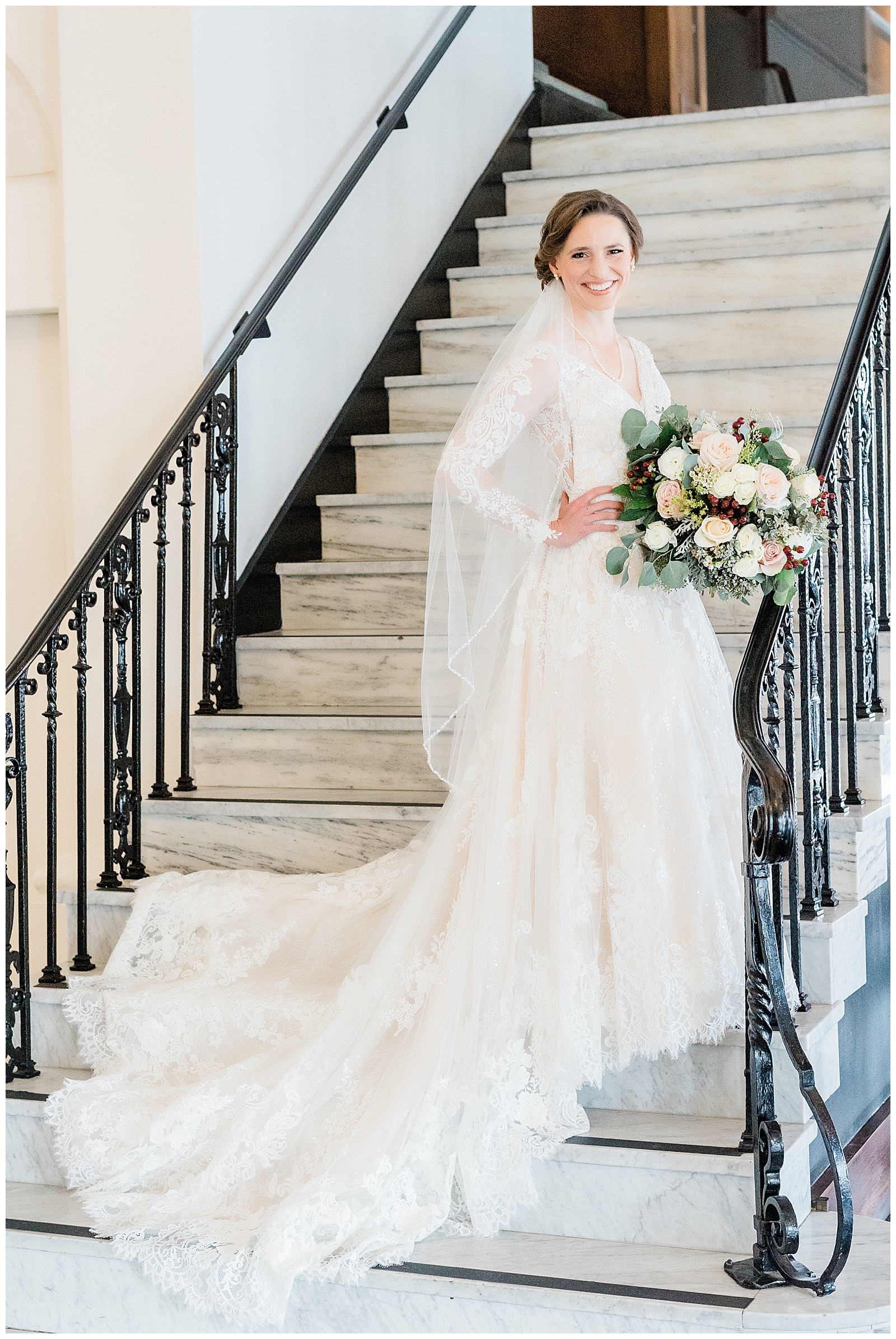 a bride poses on a staircase before her winter wedding in Bakersfield, CA