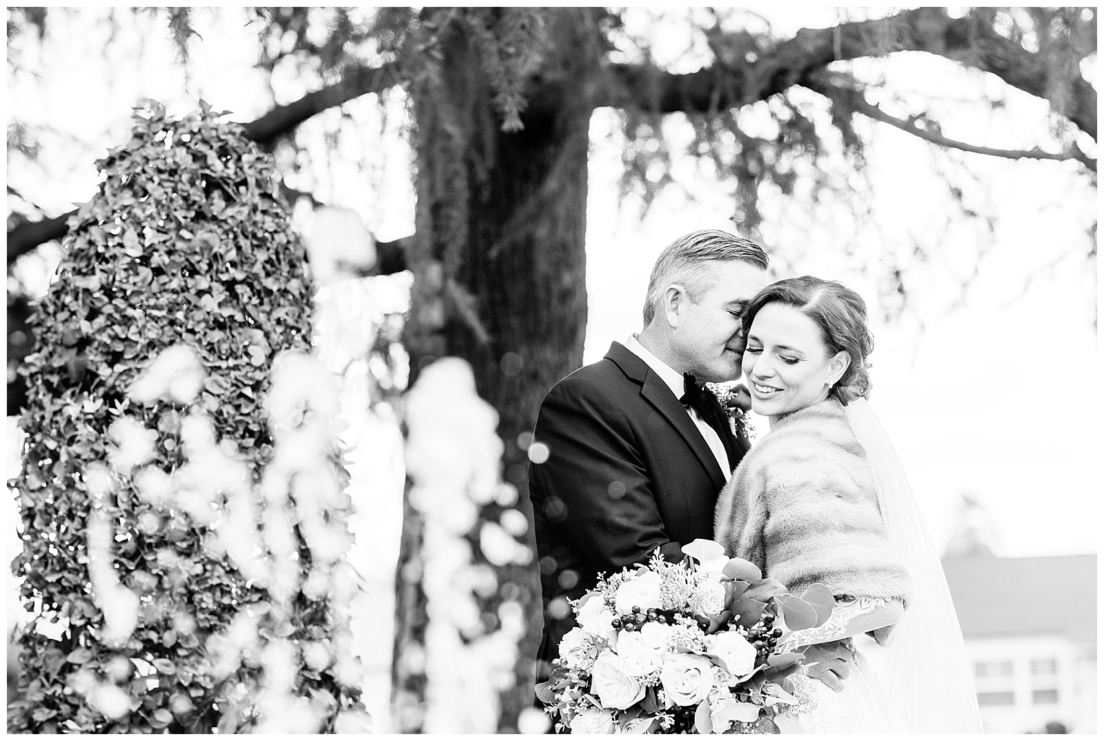 a black and white photo of a couple in front of a water fountain after their winter wedding in Bakersfield, CA