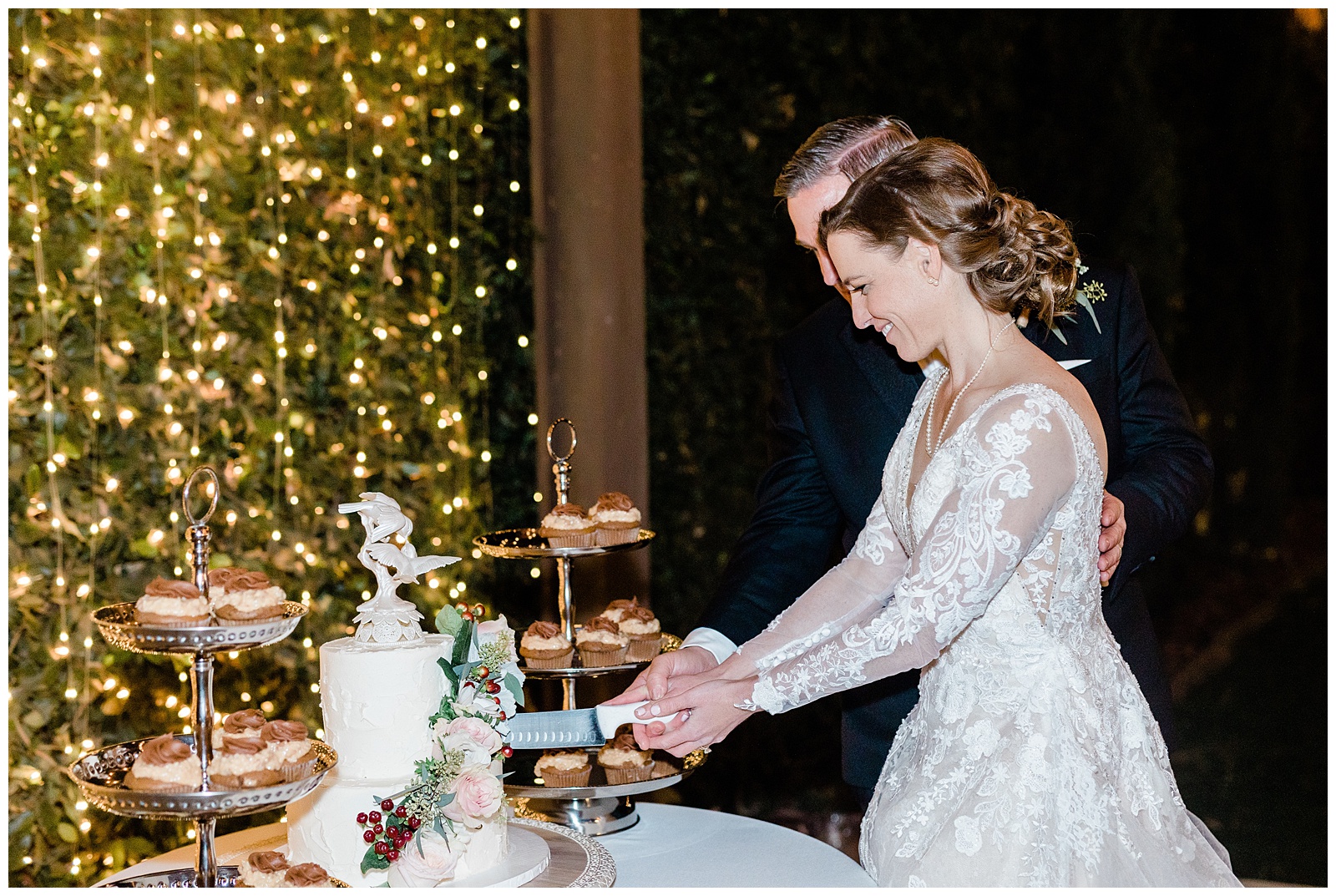 a bride and groom cut the cake at their winter wedding in Bakersfield, CA