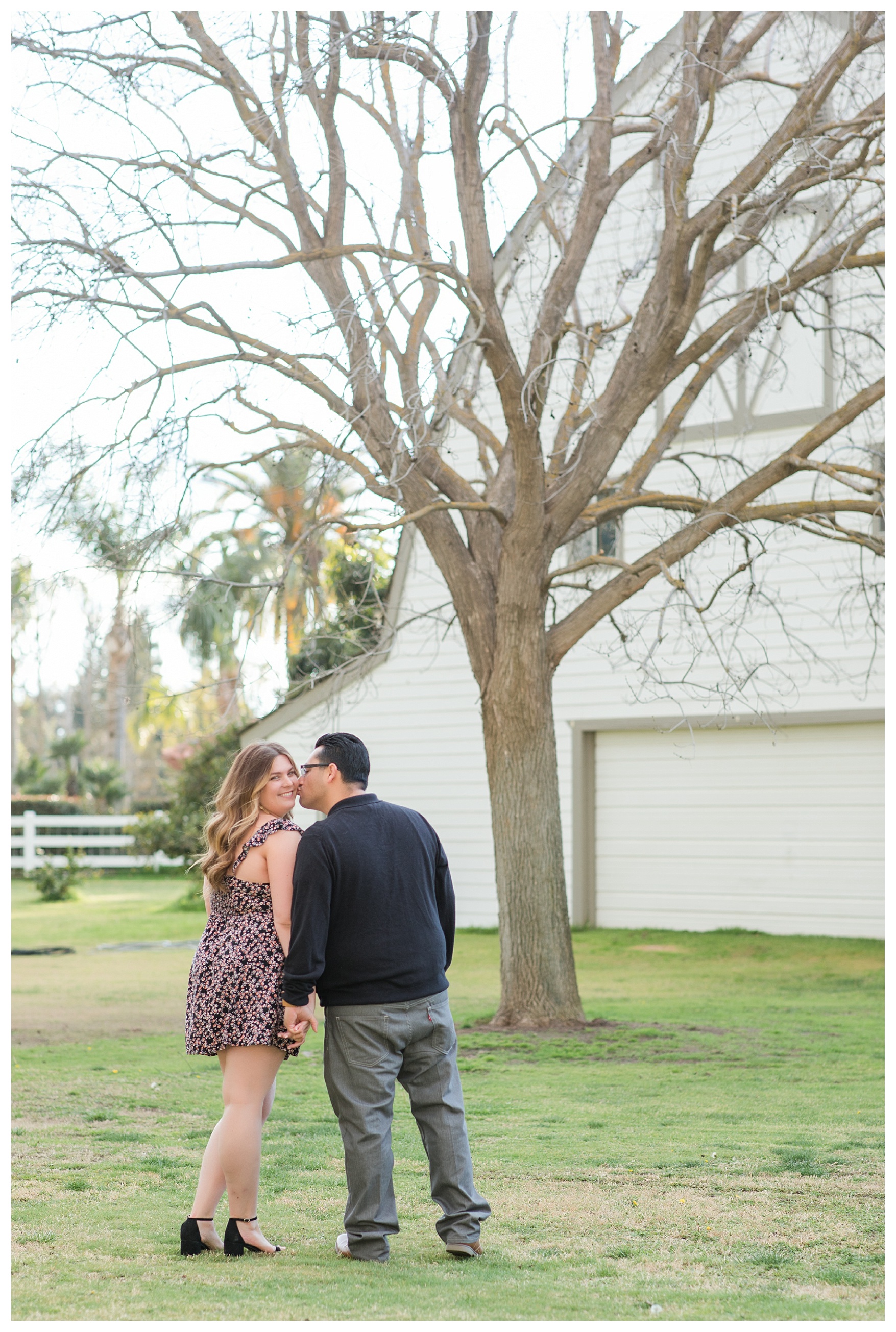 a groom kisses his bride on the cheek during their beautiful fall engagement session in Bakersfield