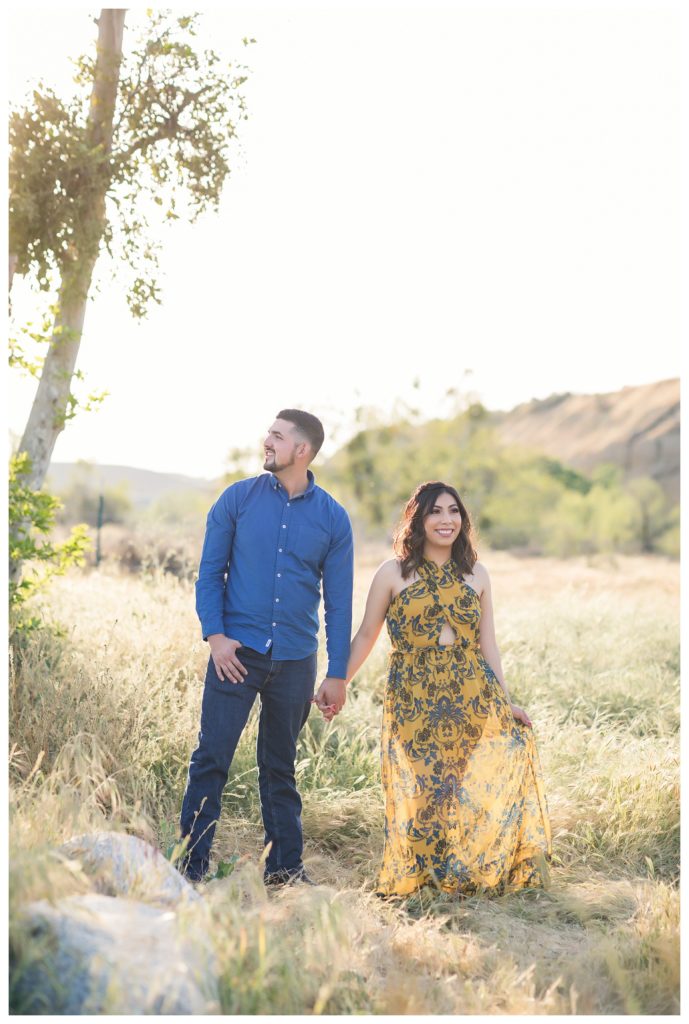 a couple looking off into the distance during their Kern County engagement photos