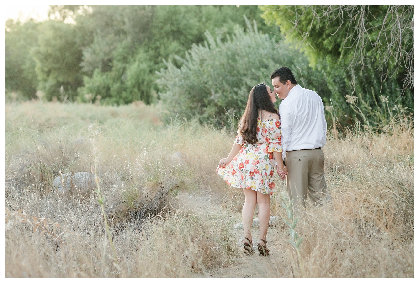 stealing a kiss during a sunset engagement session at Kern River